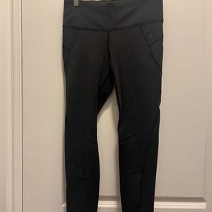 Athleta leggings with cut out dot detail on legs. Size medium. Black.